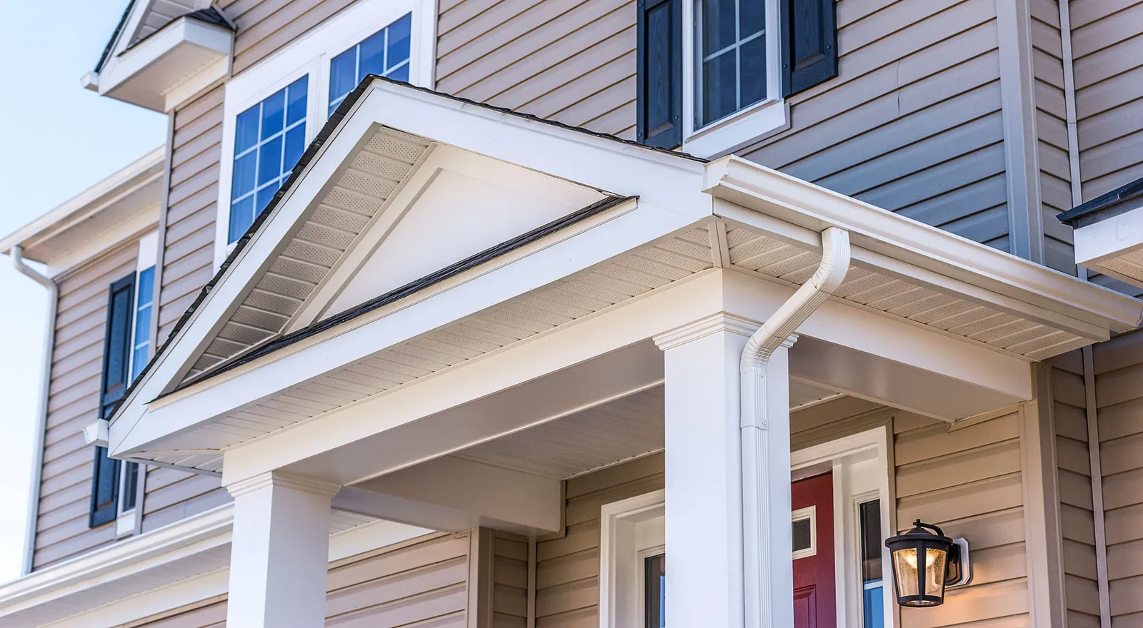 White seamless gutters on a covered porch — Ferrari Gutter Services, greater Akron area